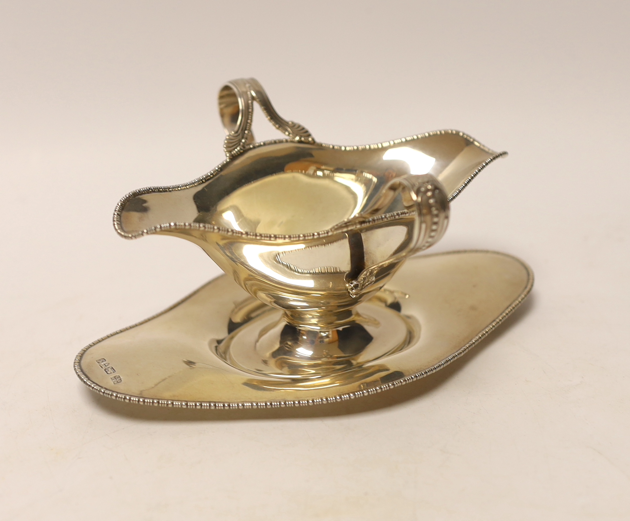 An Edwardian silver double lipped sauceboat and stand, Barker Brothers, Chester, 1907, stand 17.9cm, 6.4oz.